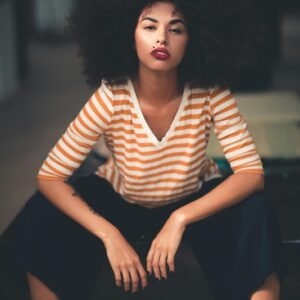 Fashionable portrait of a stylish woman with afro hairstyle in casual chic attire.
